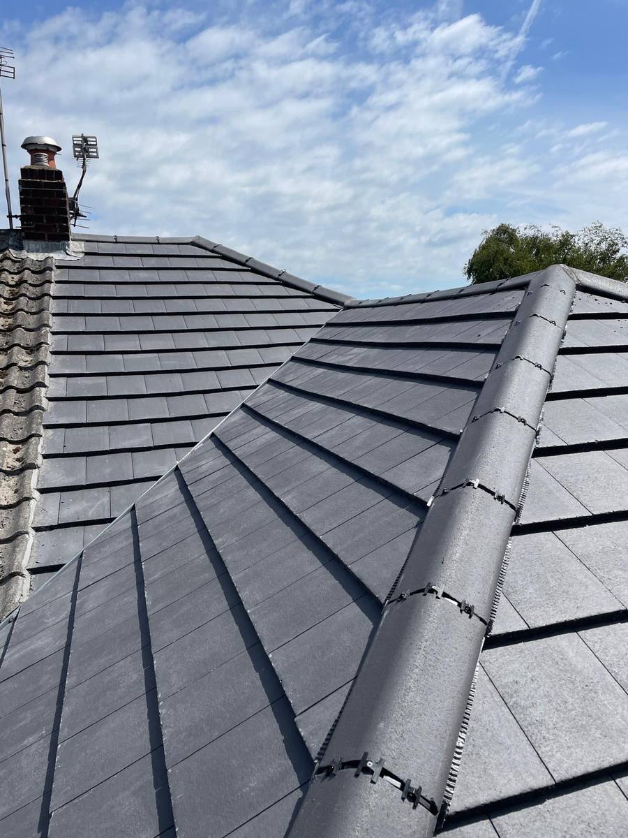 After: completed full roof replacement with terracotta clay tiles