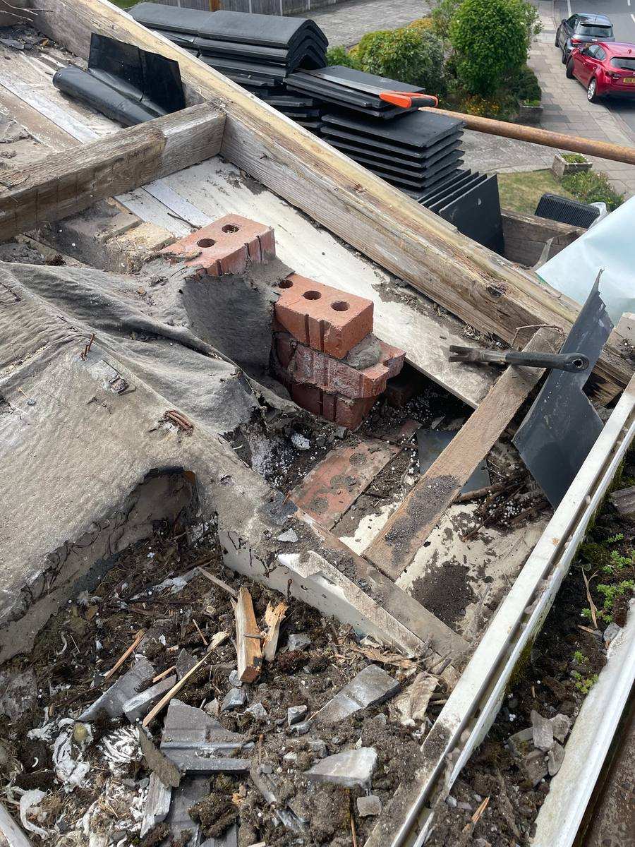 Before: worn roof tiles prior to full replacement