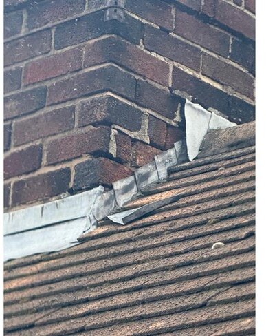 Defective and incomplete leadwork at a chimney abutment &mdash; roof survey, Maghull