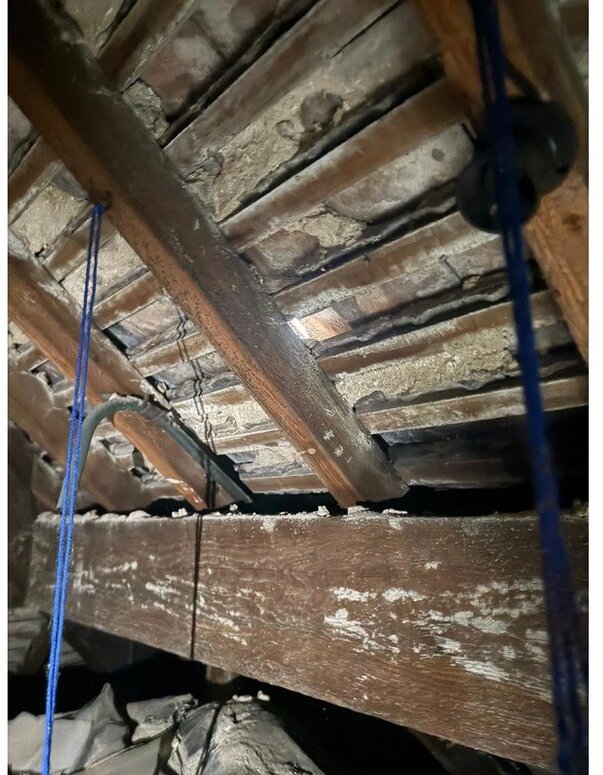 Failed lime-mortar torching and open tile joints viewed from the loft &mdash; roof survey, Maghull