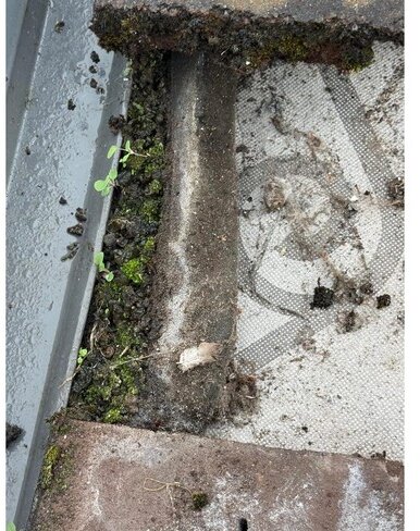 Debris obstructing a roof-window drainage channel &mdash; roof survey, Maghull